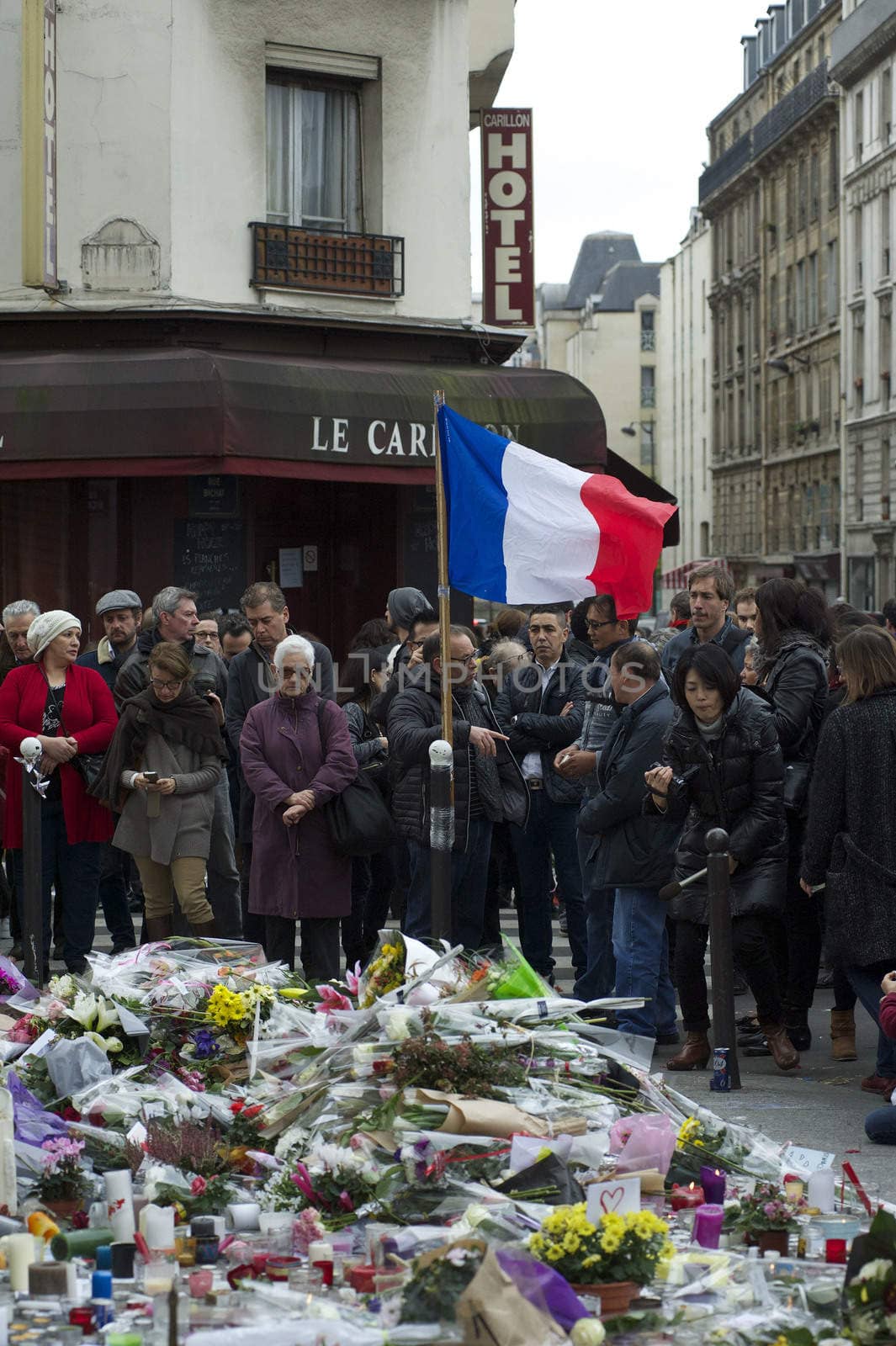 FRANCE, Paris: People gathered at Le Carillon restaurant, one of the Paris attacks' crime scenes, to participate in a minute of silence for the victims of the attacks, on November 16, 2015. At least 129 people were killed and more then 350 critically injured in a series of overnight terror attacks in Paris from 13 to 14 November 2015.