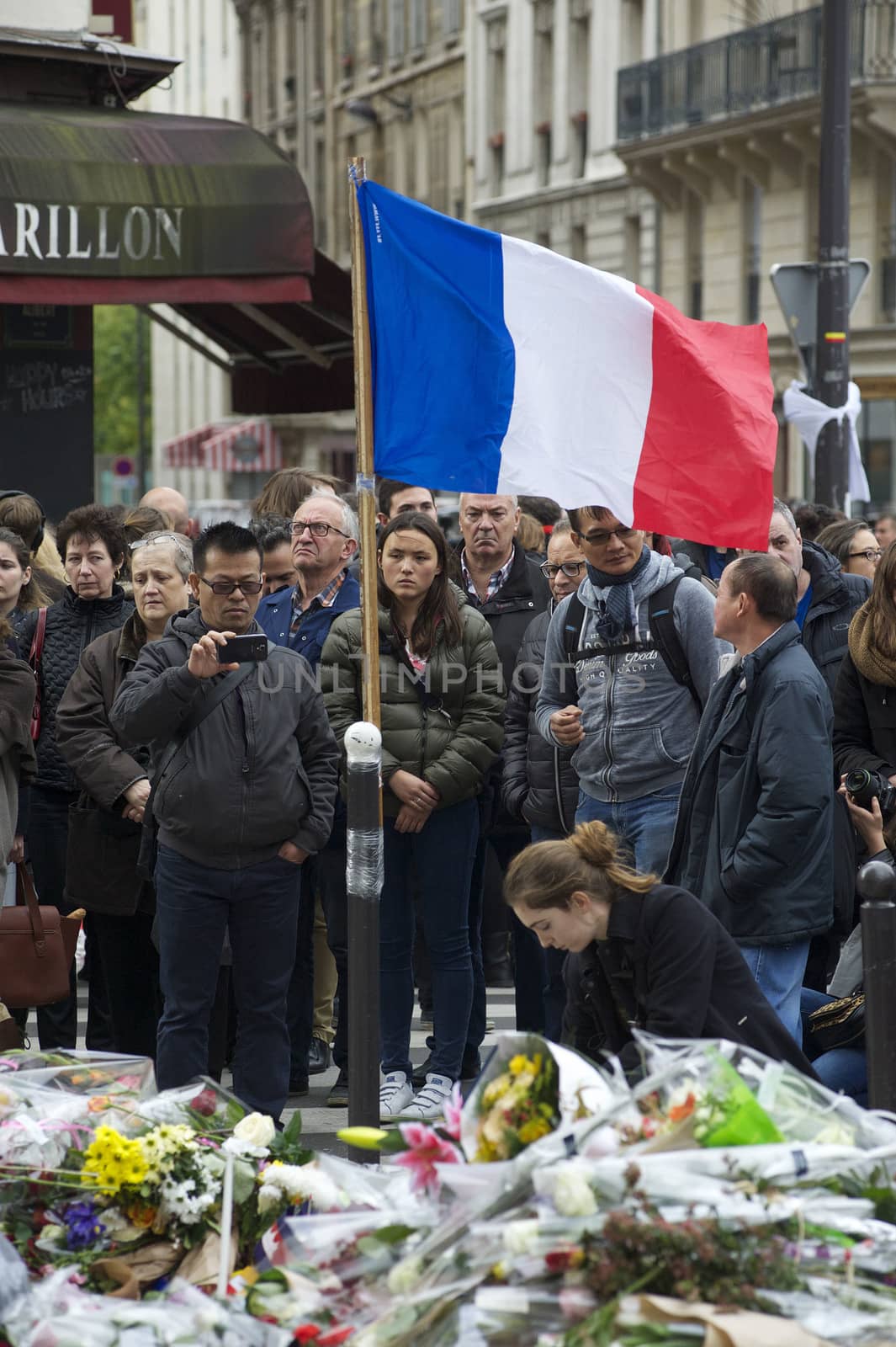 FRANCE, Paris: People gathered at Le Carillon restaurant, one of the Paris attacks' crime scenes, to participate in a minute of silence for the victims of the attacks, on November 16, 2015. At least 129 people were killed and more then 350 critically injured in a series of overnight terror attacks in Paris from 13 to 14 November 2015.