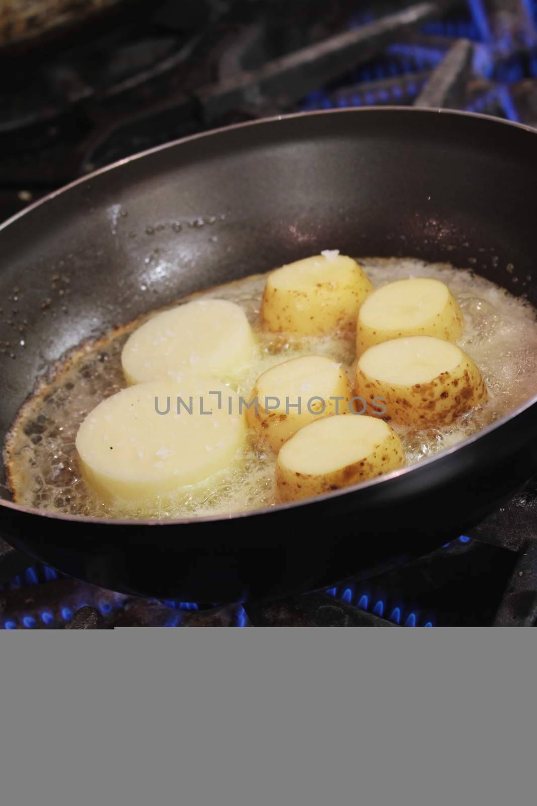 potatoes frying in pan