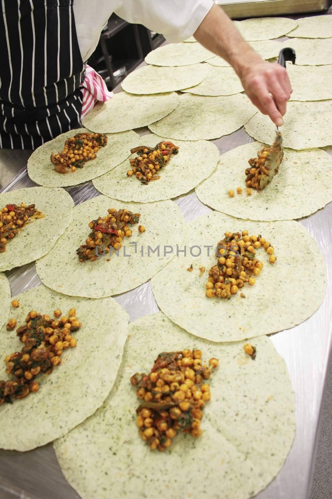 chef preparing indian chick pea wrap