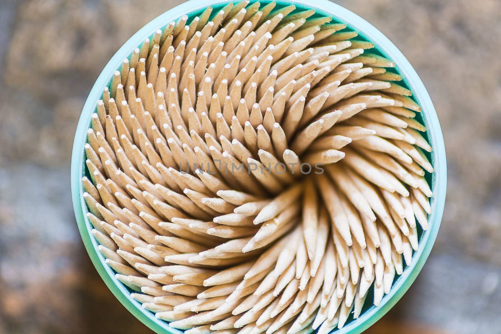 a bunch of toothpicks in a round box