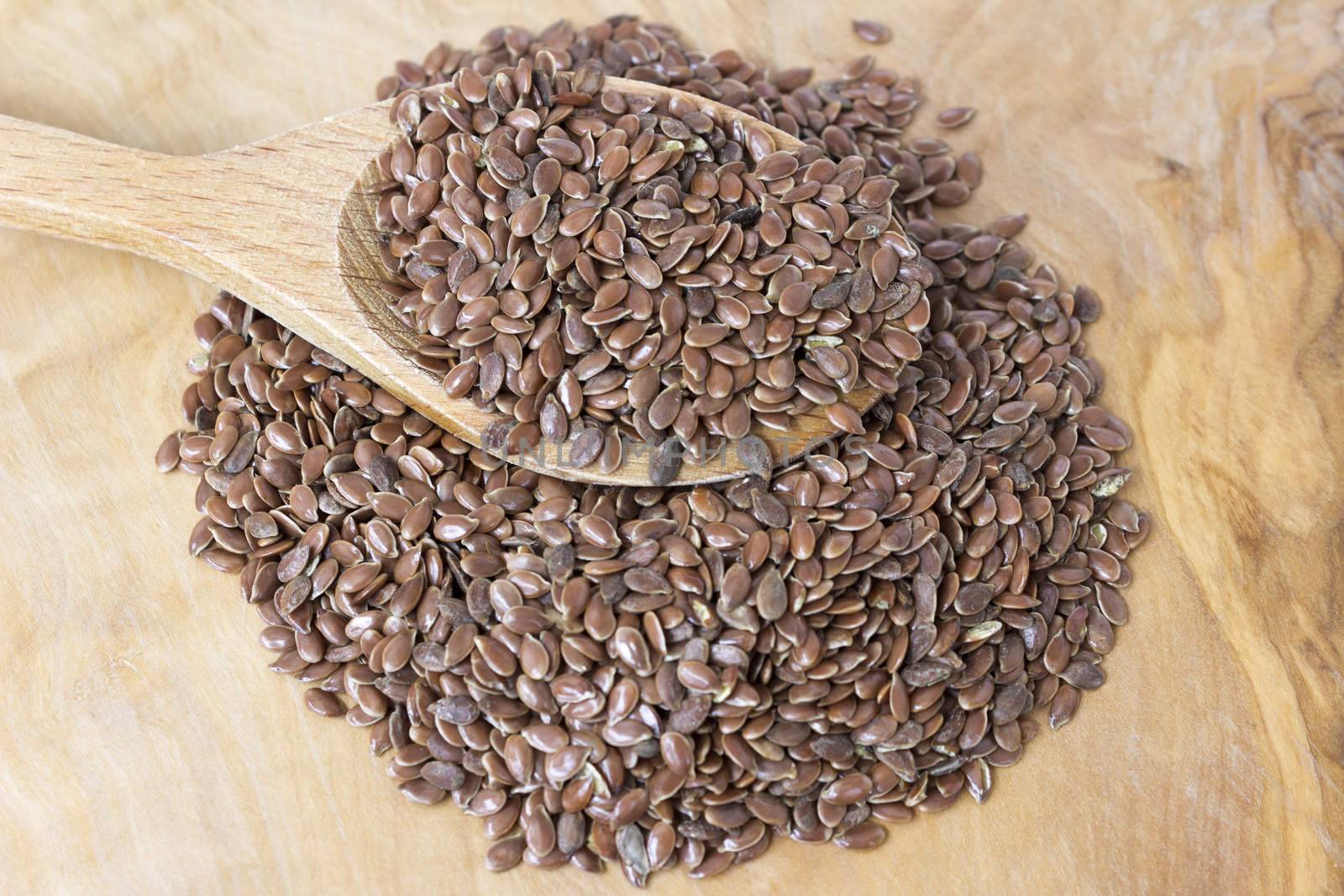 Flax seeds with a wooden spoon by Kidza