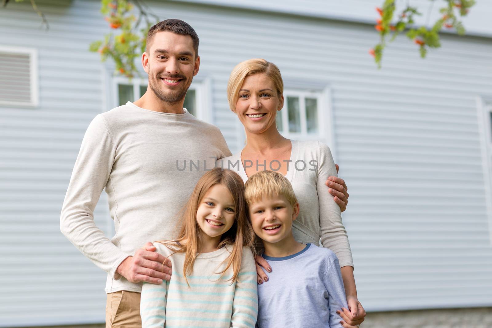 happy family in front of house outdoors by dolgachov