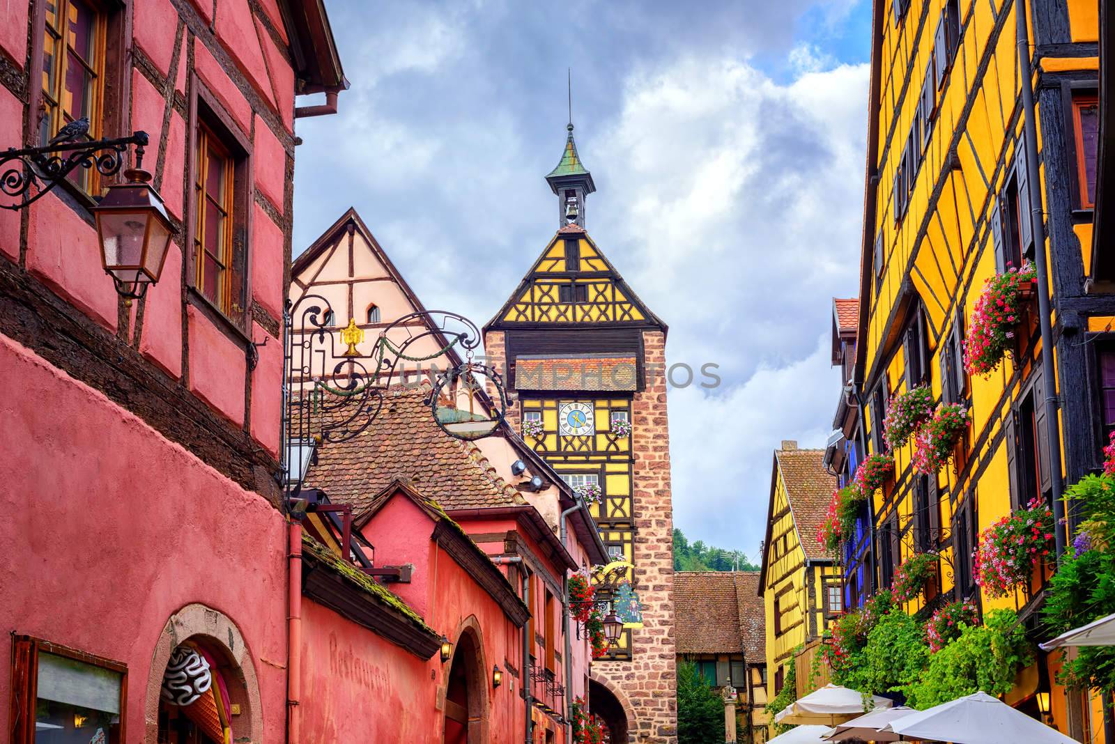 Colorful houses on a central street in Riquewihr, village on wine route in Alsace, France