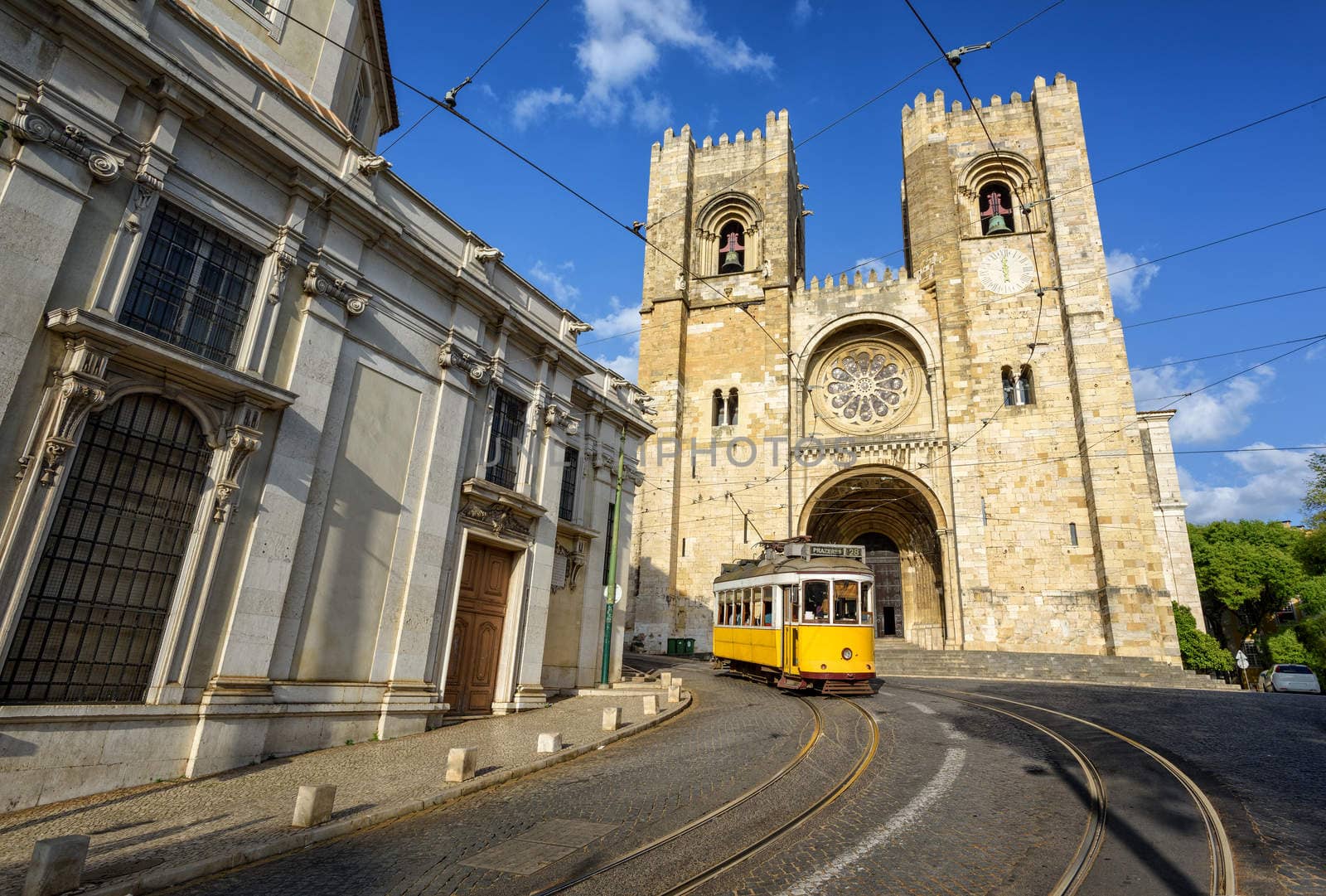 Old tram in front of cathedral in Lisbon, Portugal by GlobePhotos