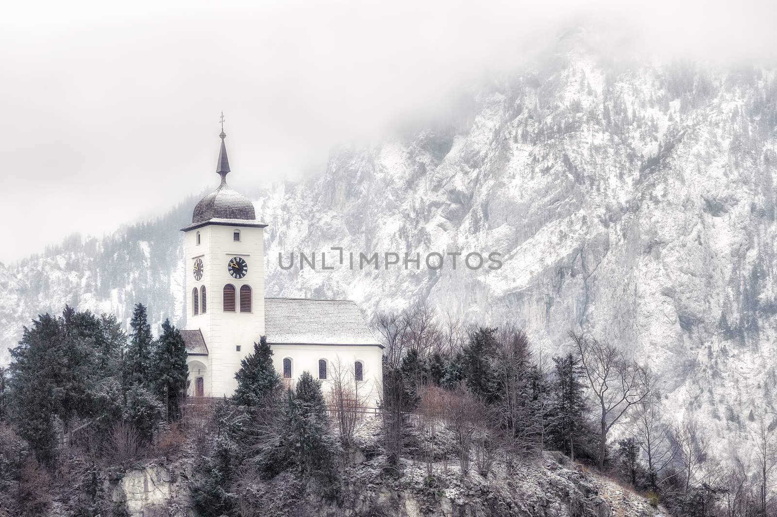 Cristian church on a snow covered hill in winter near Salzburg, Austria