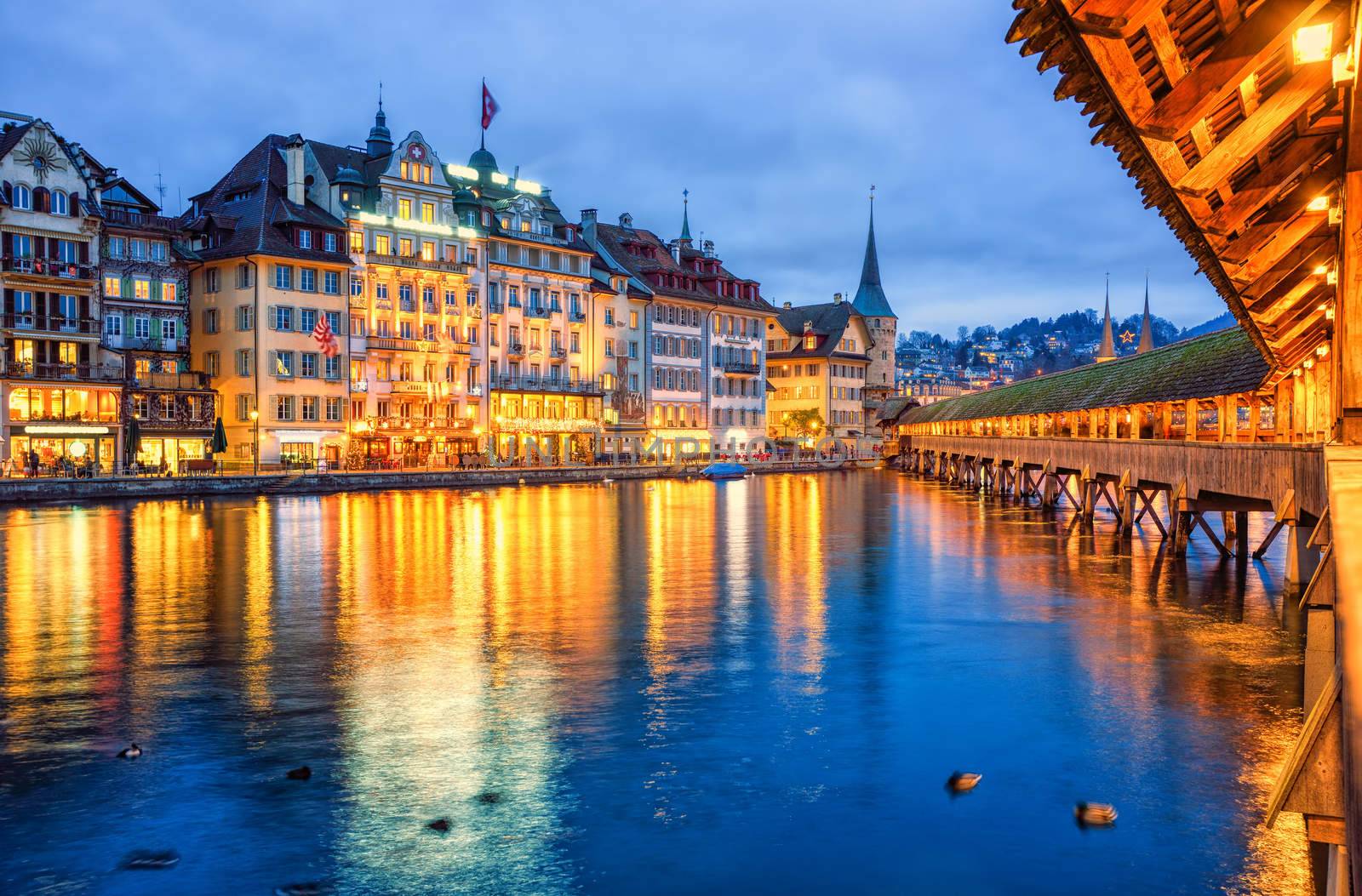 Lucerne, Switzerland, view of the old town from wooden Chapel bridge in the evening