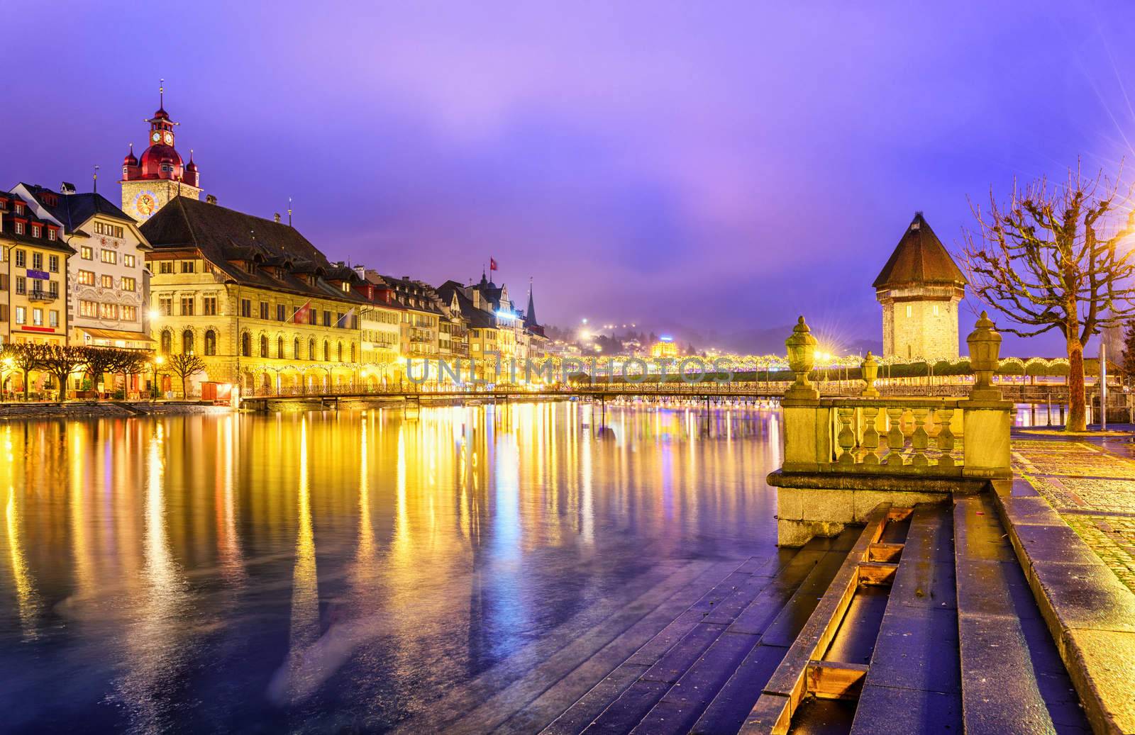 Lucerne, Switzerland. View over Reuss river to the old town and Water tower in the evening.