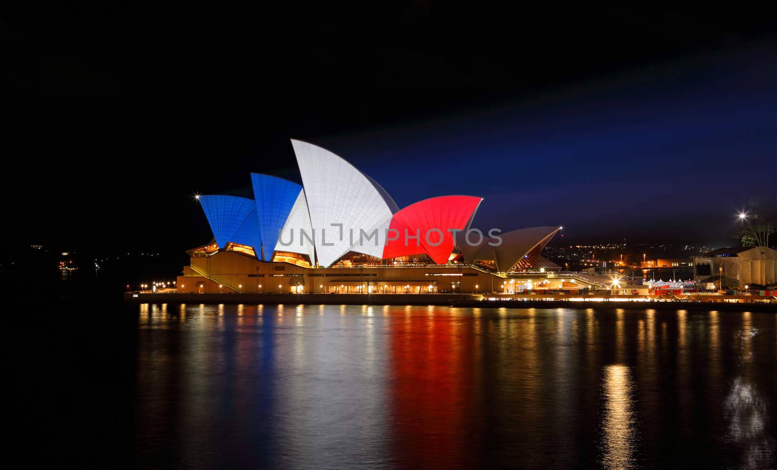 SYDNEY, AUSTRALIA - NOVEMBER 16, 2015;  Sydney Opera House lit up in colours of the French flag... blue, white and red in support of mulitple tragic terrorist events in France  by an islamic extremist group named ISIS