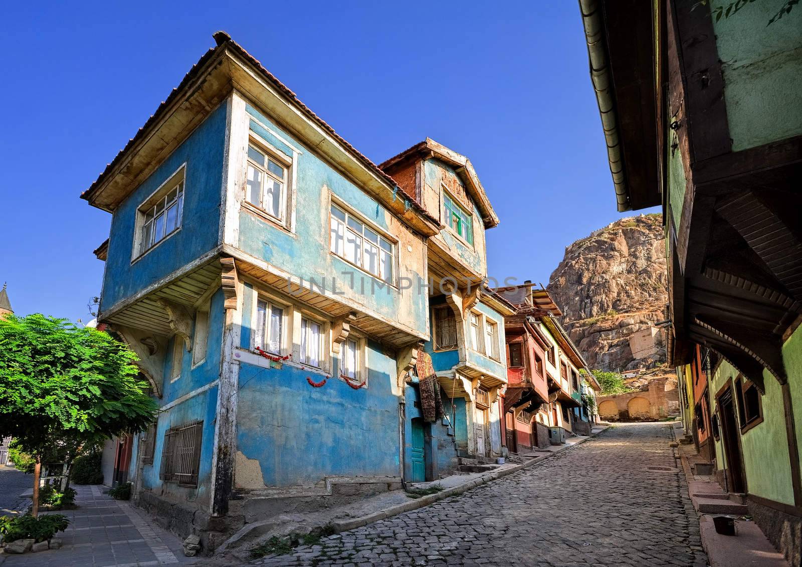 Old traditional ottoman house street with the Karahisar castle in background, Afyon, Turkey