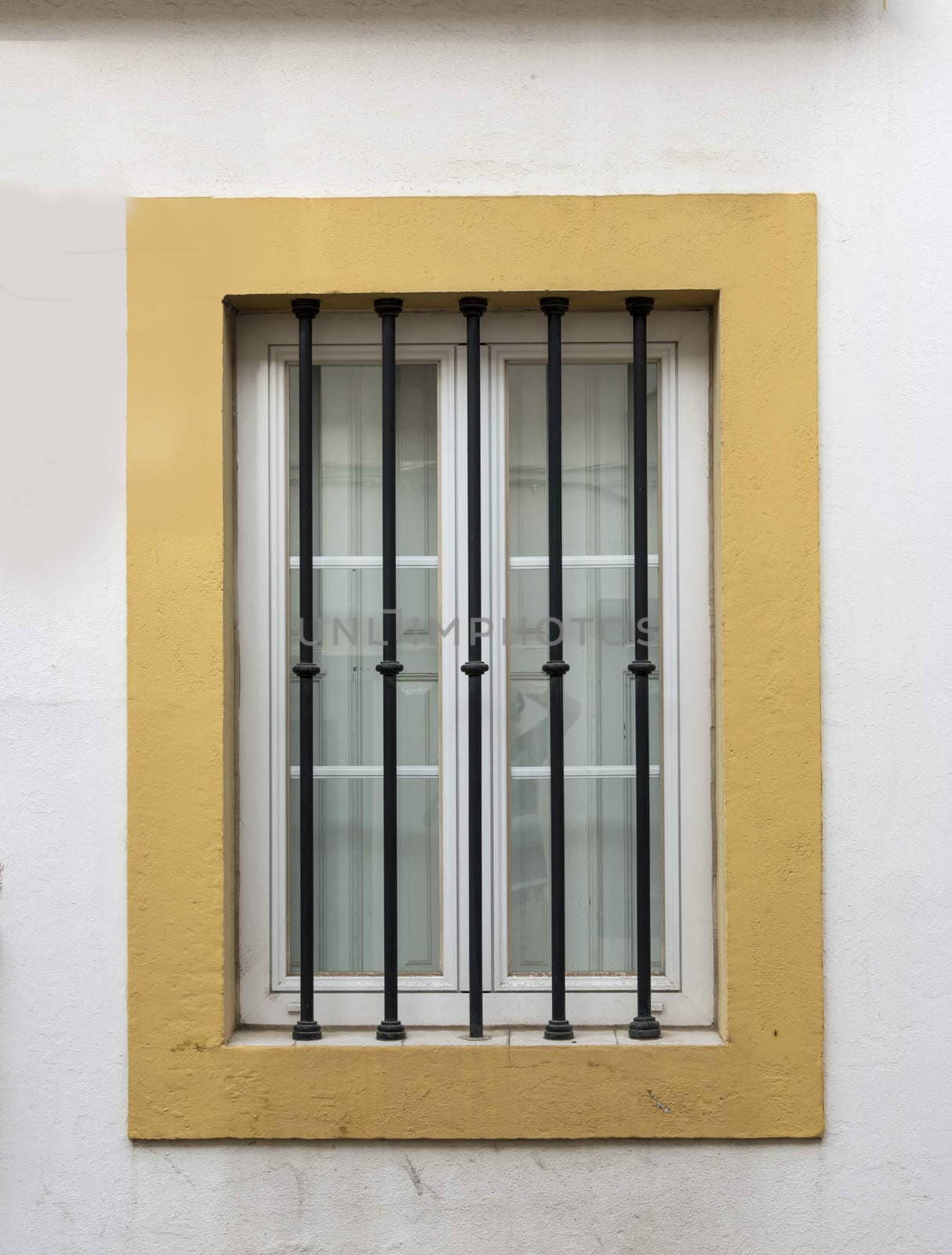 window with bars for security yellow and white