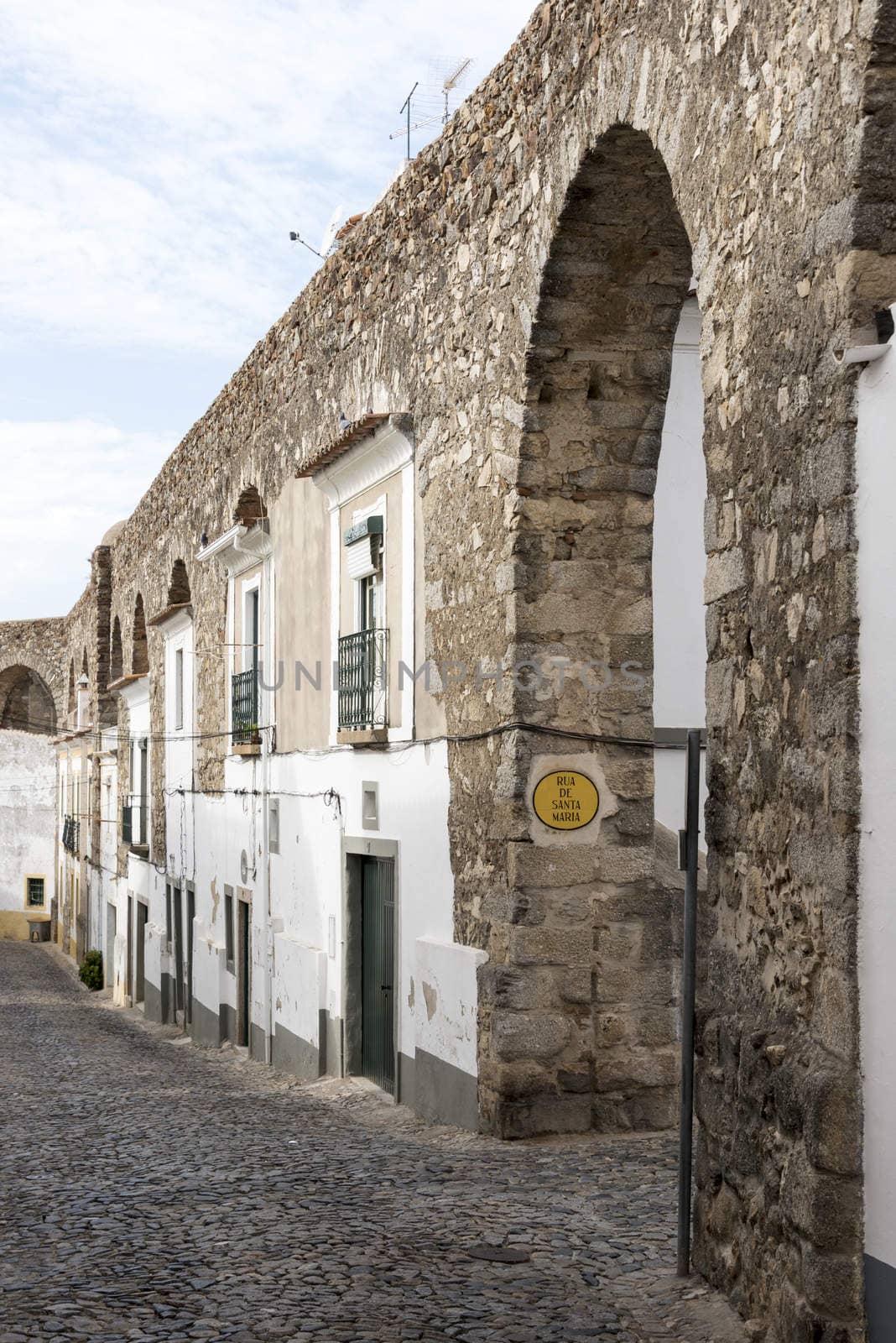houses build in the old city wall in evora alentejo Portugal