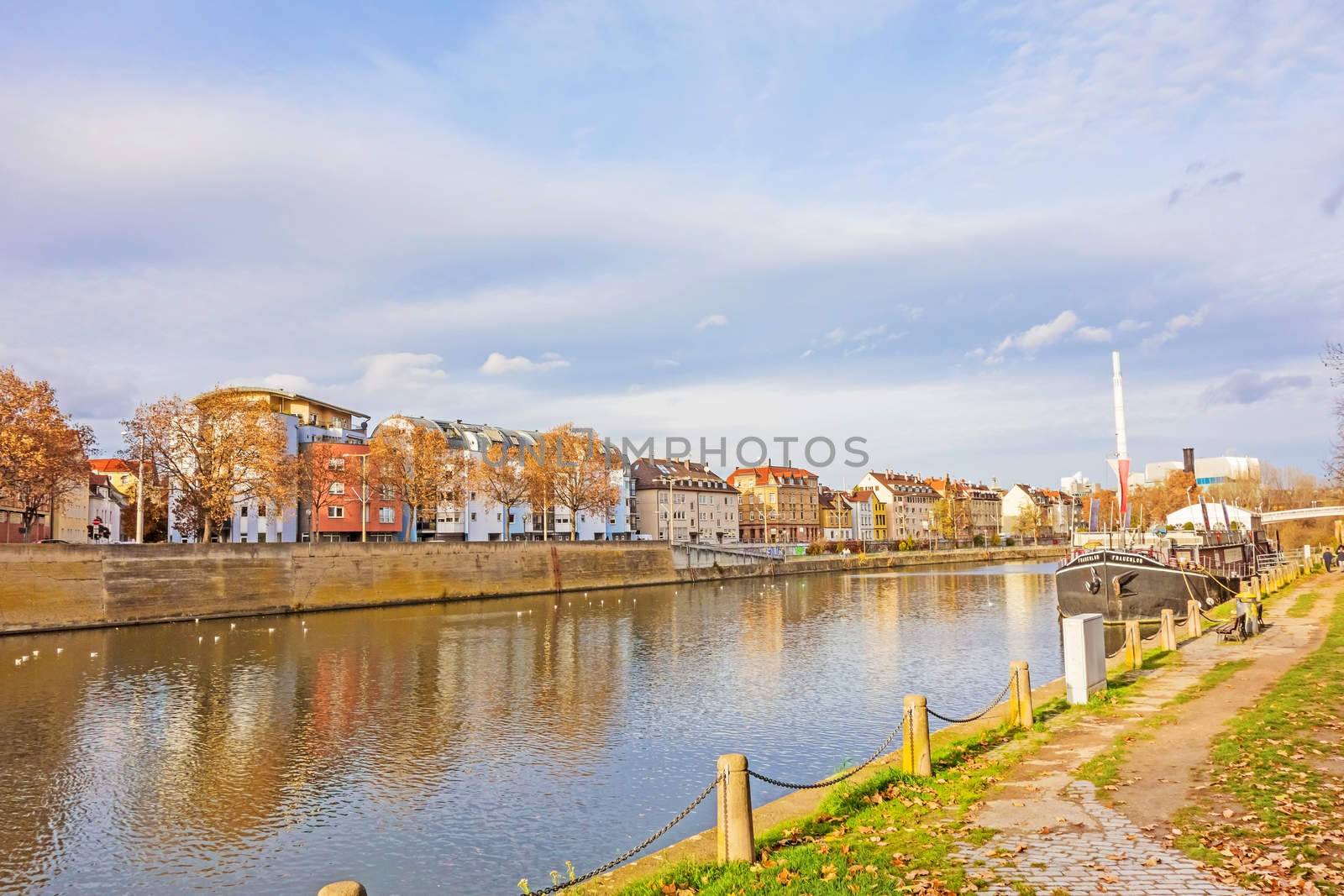 Stuttgart, Germany - November 14, 2015: River Neckar near the center of district Bad Cannstatt - road towards named Neckartalstrasse, showboat Theaterschiff Stuttgart / Frauenlob on the right.
