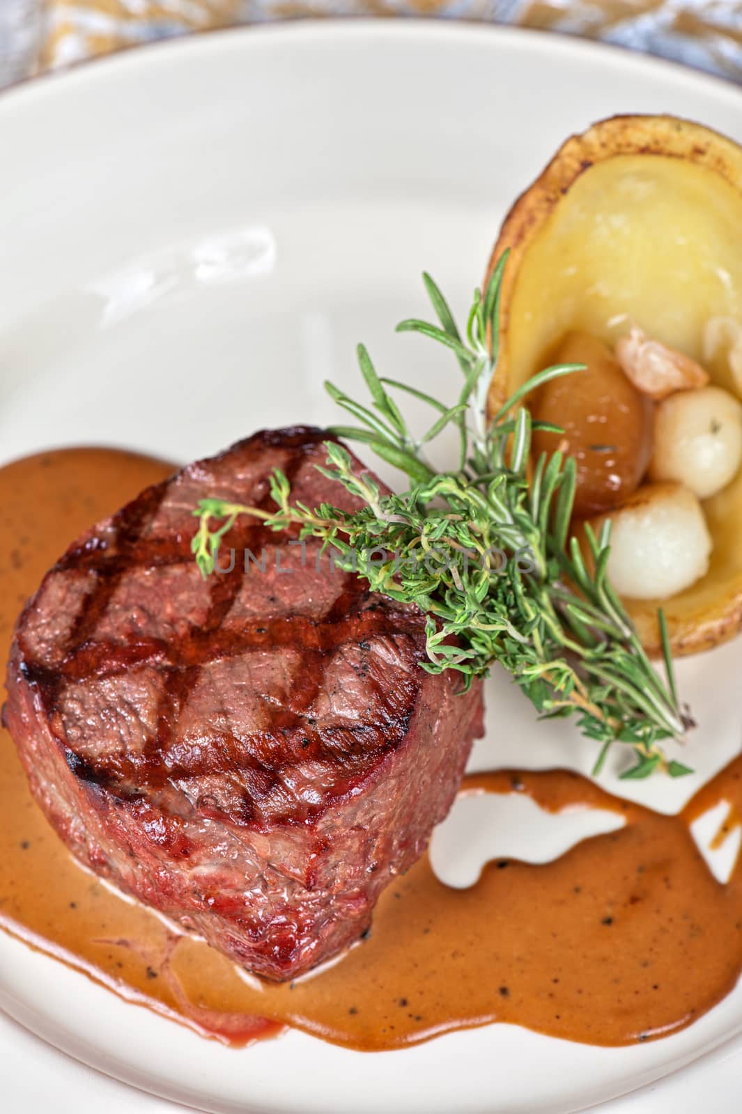 grilled beef steak with herbs and vegetables