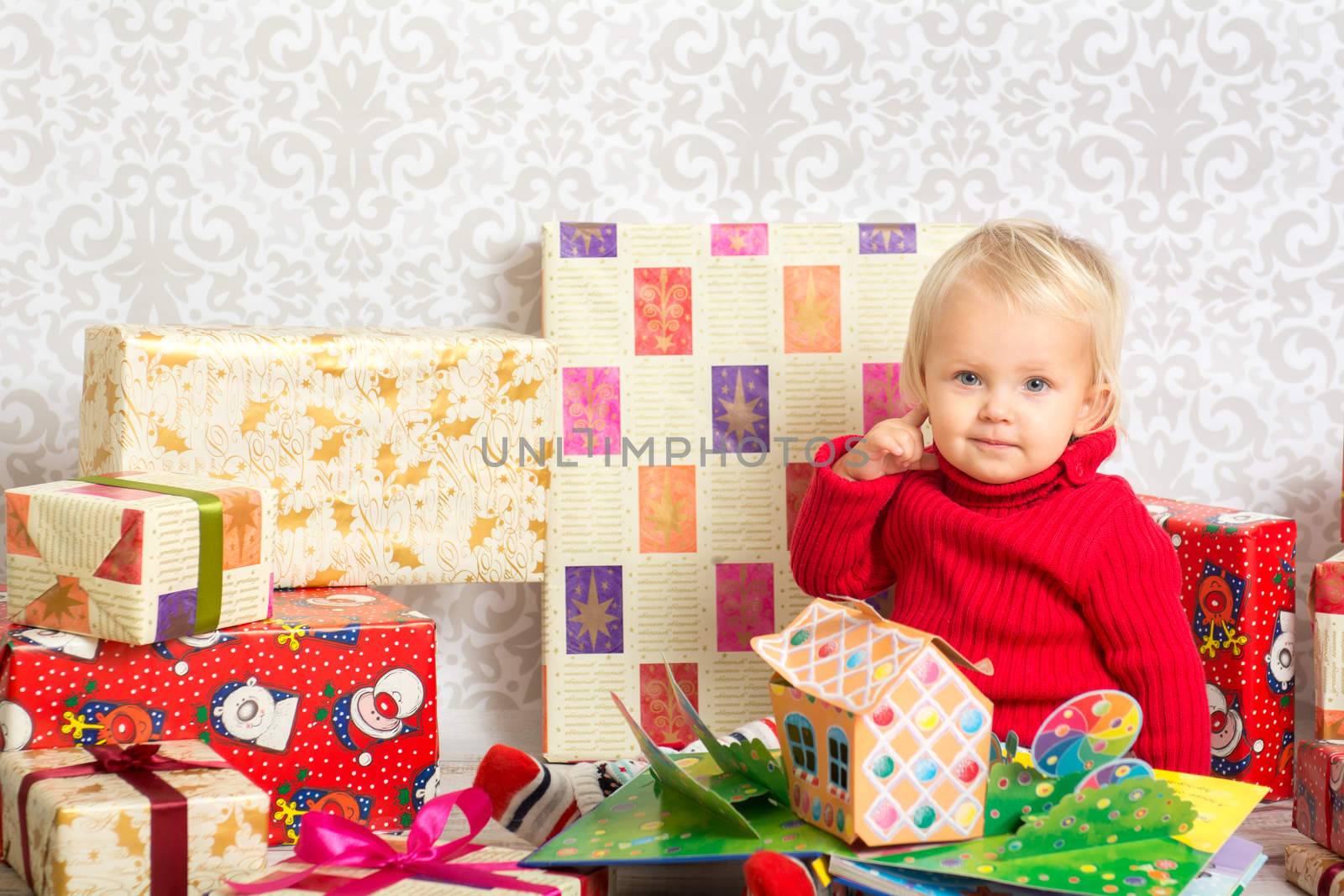 Baby girl among the christmas presents by kamsta