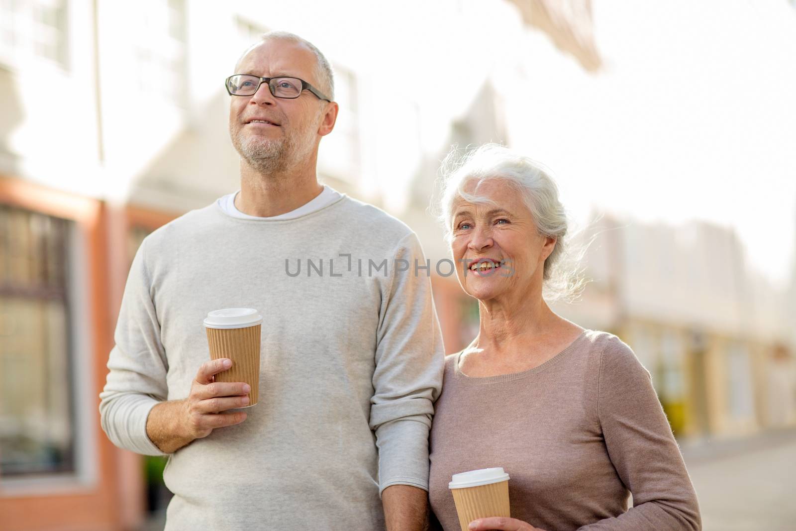 family, age, tourism, travel and people concept - senior couple on city street