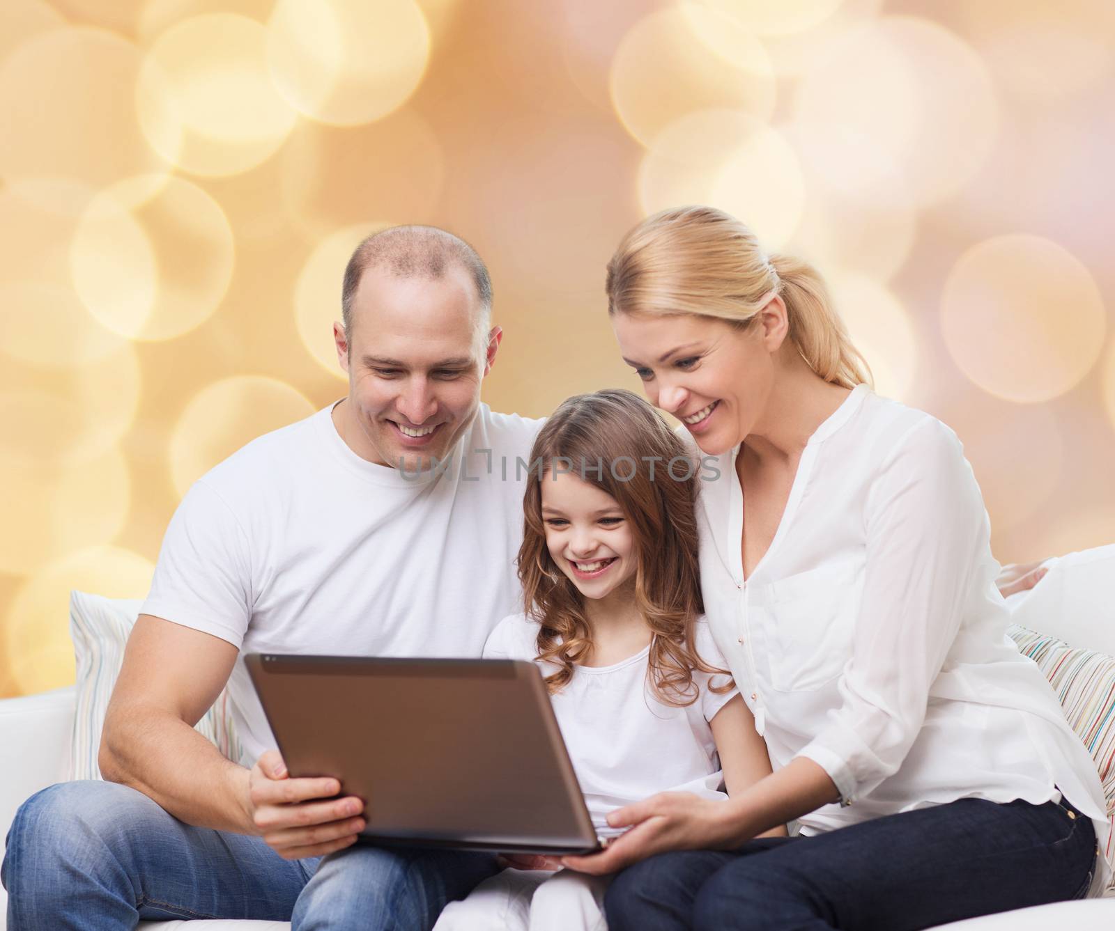 smiling family with laptop by dolgachov