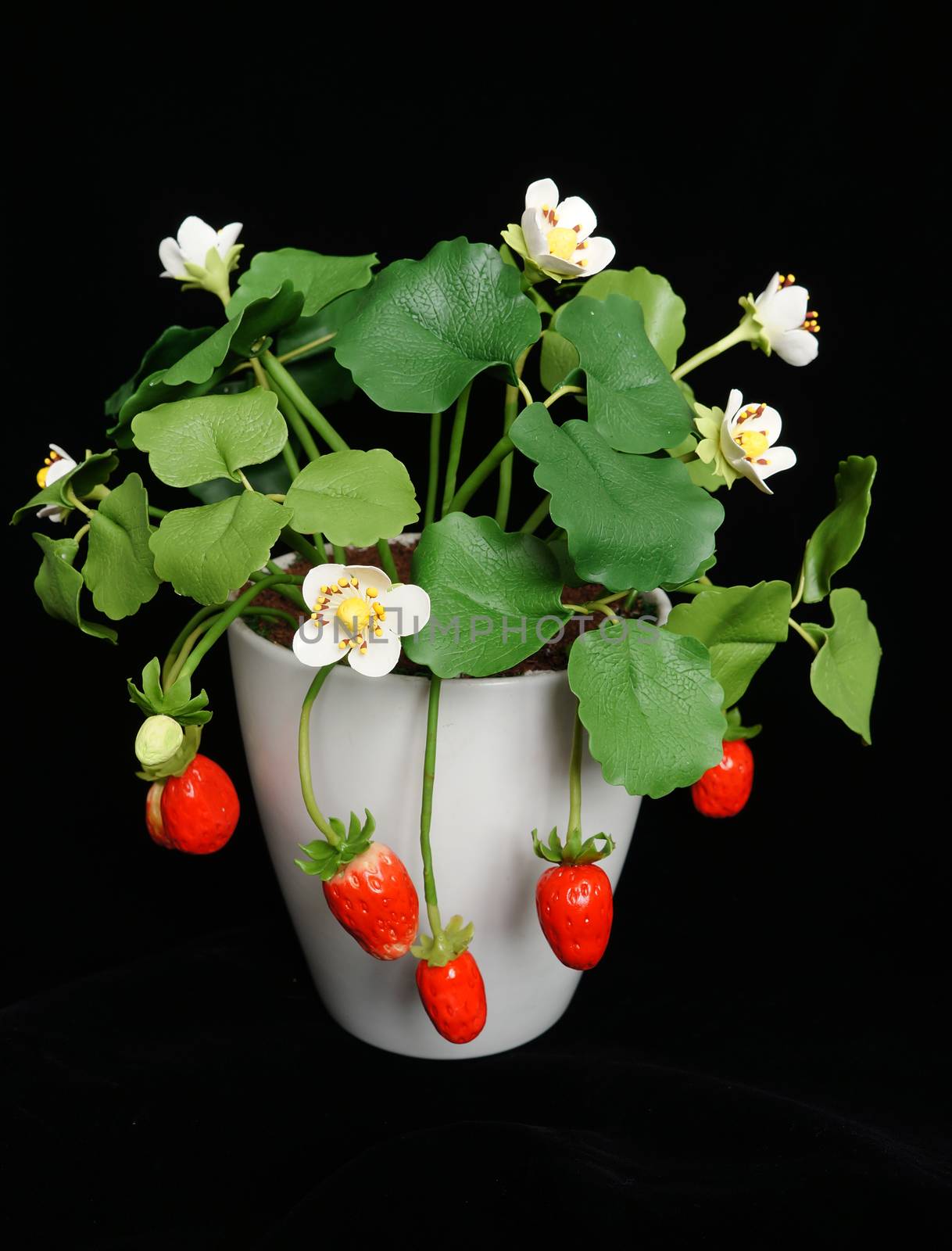 Amazing handmade product on black background, clay flower as pink lotus flower, orange orchid, violet bloom, strawberry pot make home made, beautiful artificial flowers