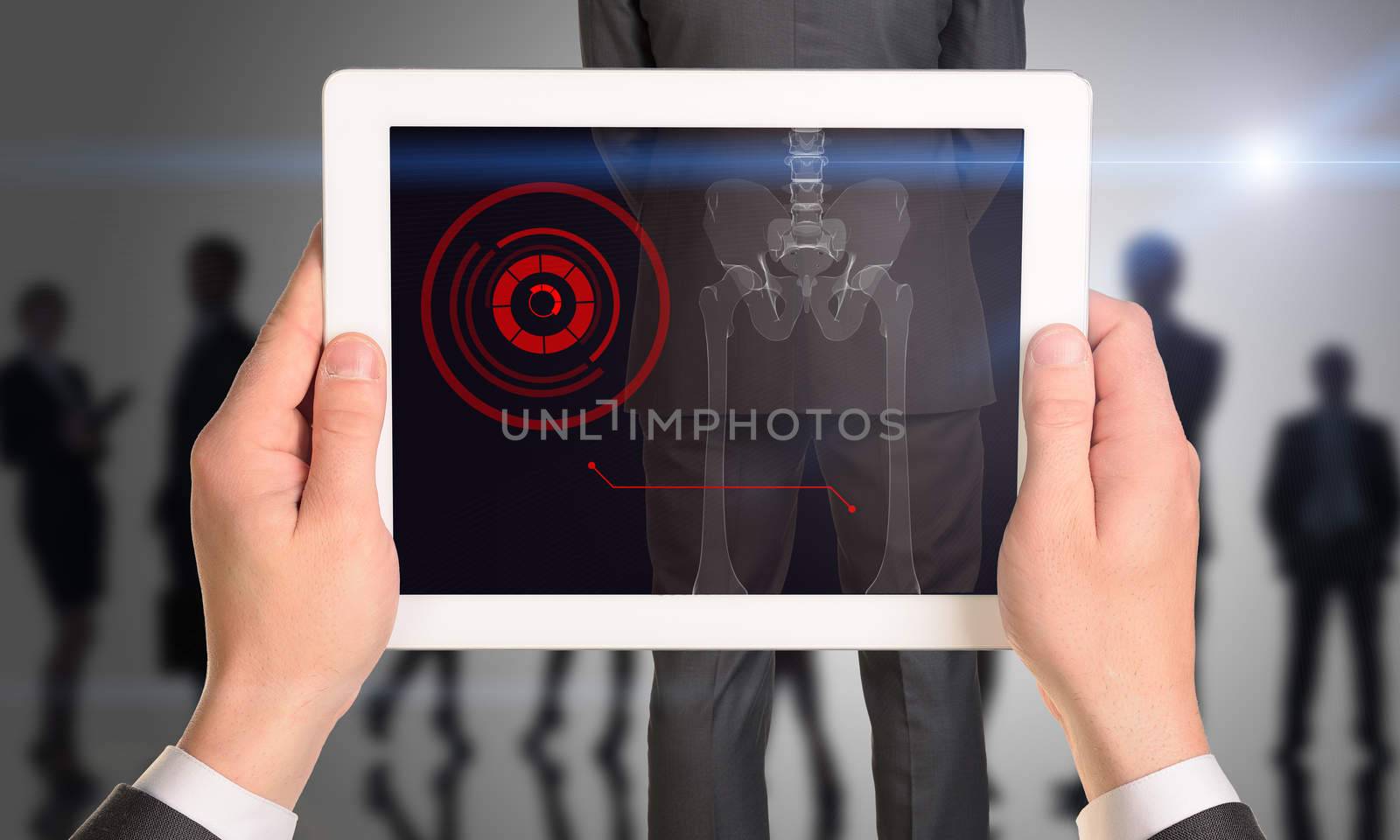 Businessman holding tablet with x-ray of man