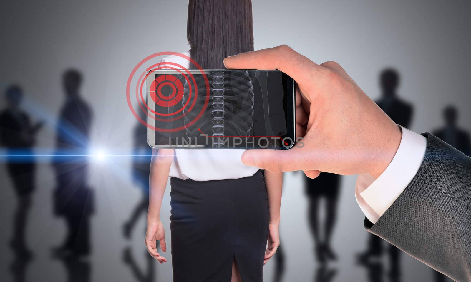 Businessman holding smartphone with x-ray of woman