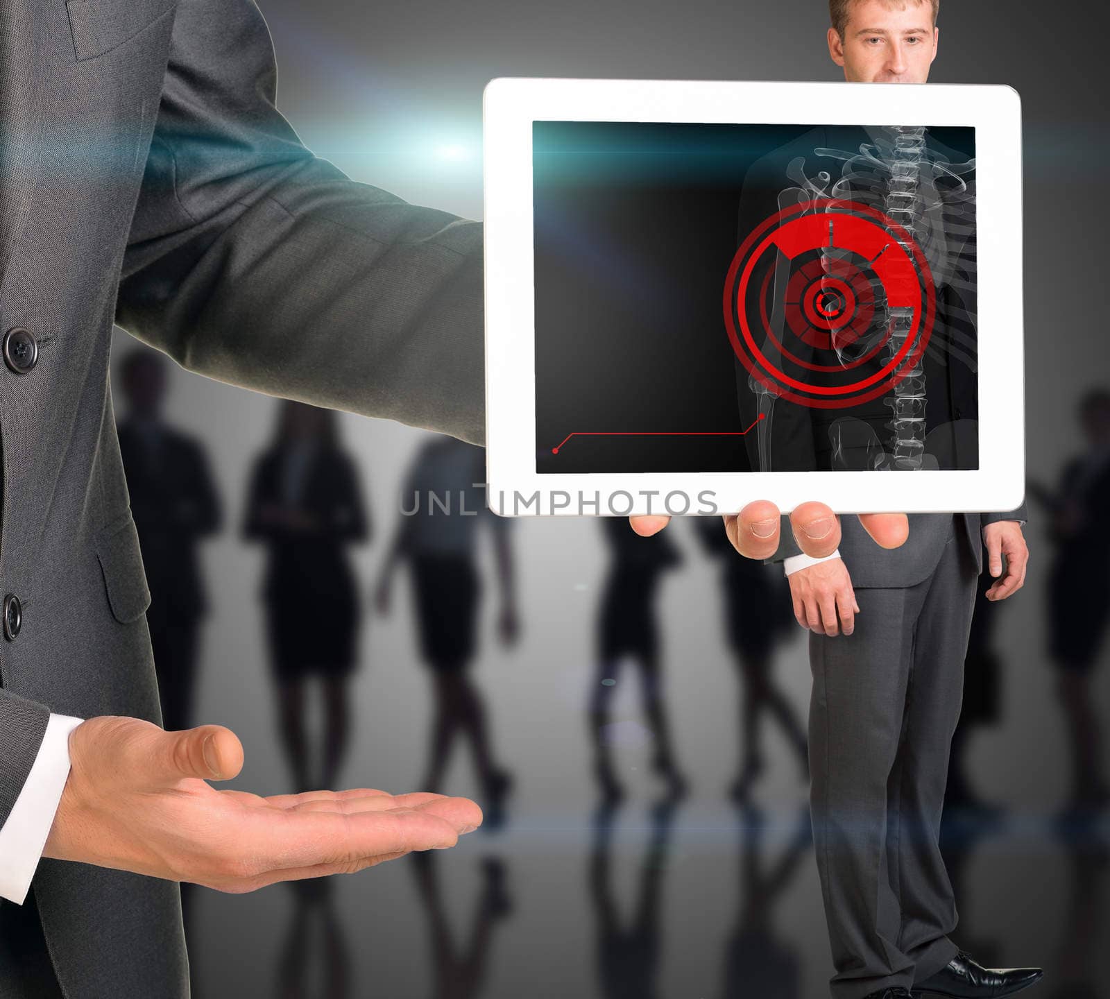 Businessman holding tablet with x-ray of man