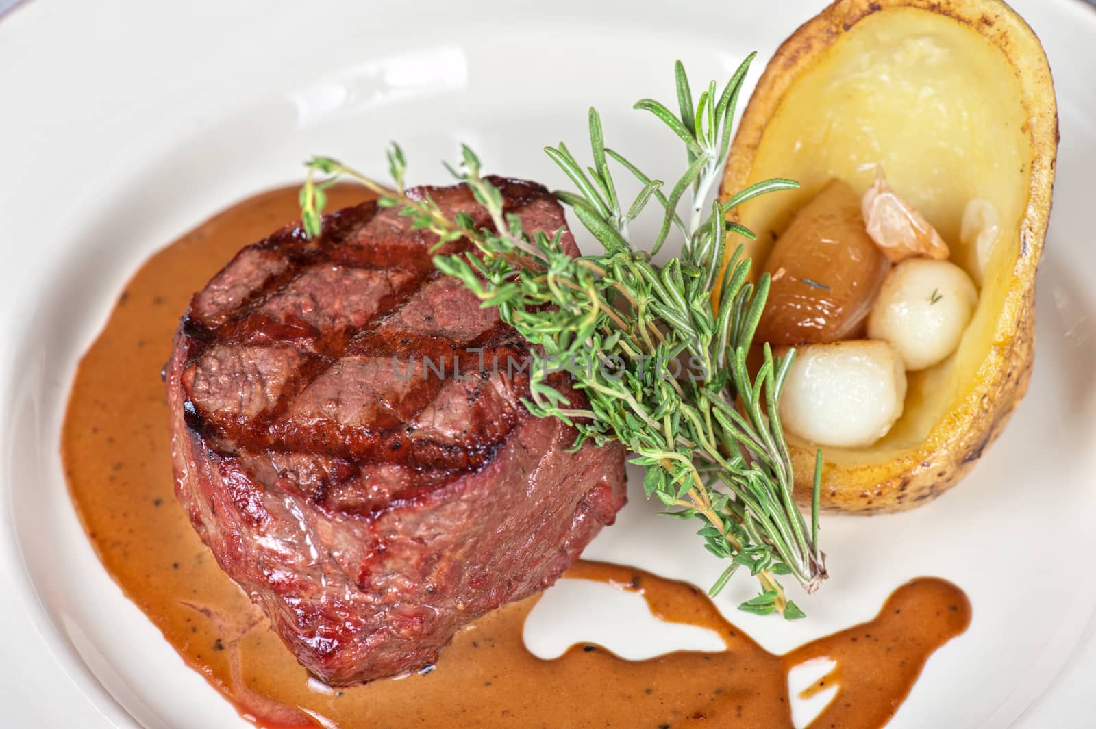 grilled beef steak with herbs and vegetables