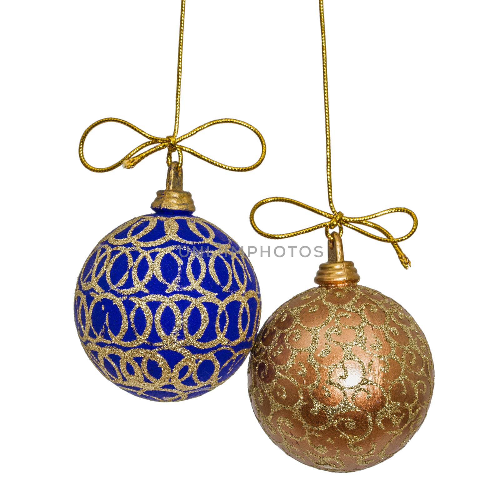 Beautiful Christmas balls are suspended on a gold thread, isolated on white background