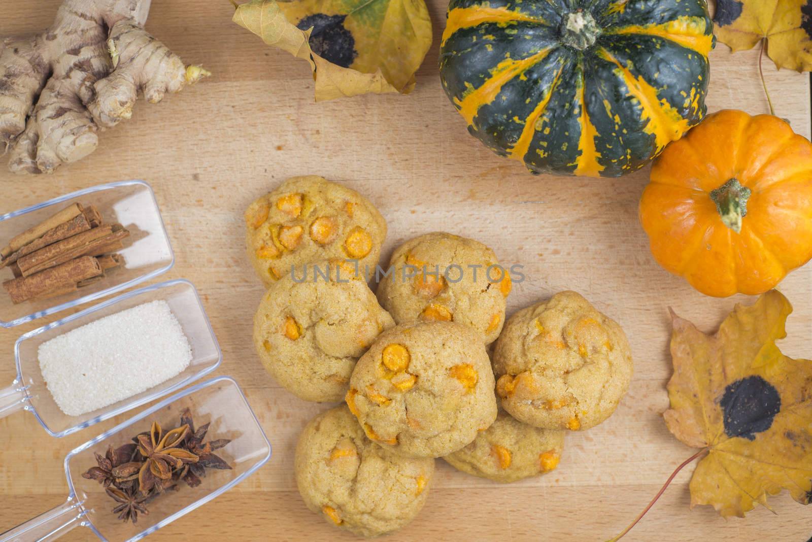 Spice pumpkin homemade cookies against wood background with ingredients