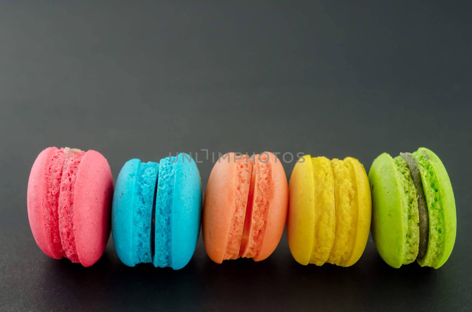 Row of french colorful macaroons. by Gamjai