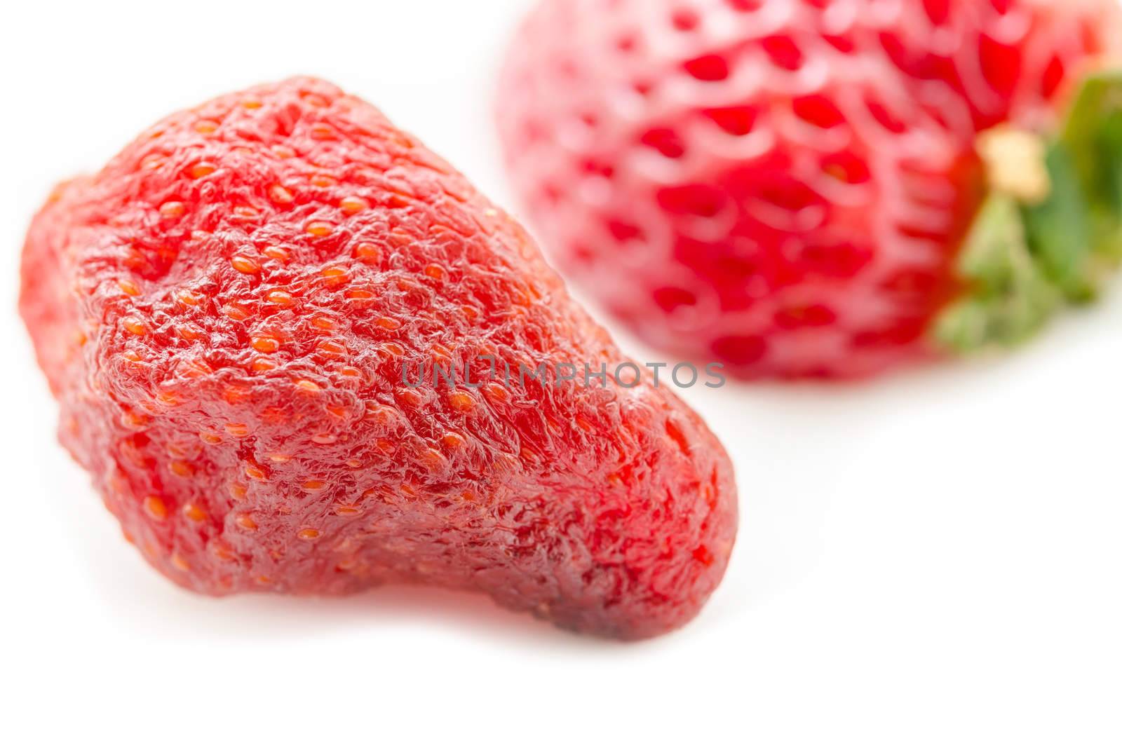 Close up dry strawberry with fresh strawberry on white background.