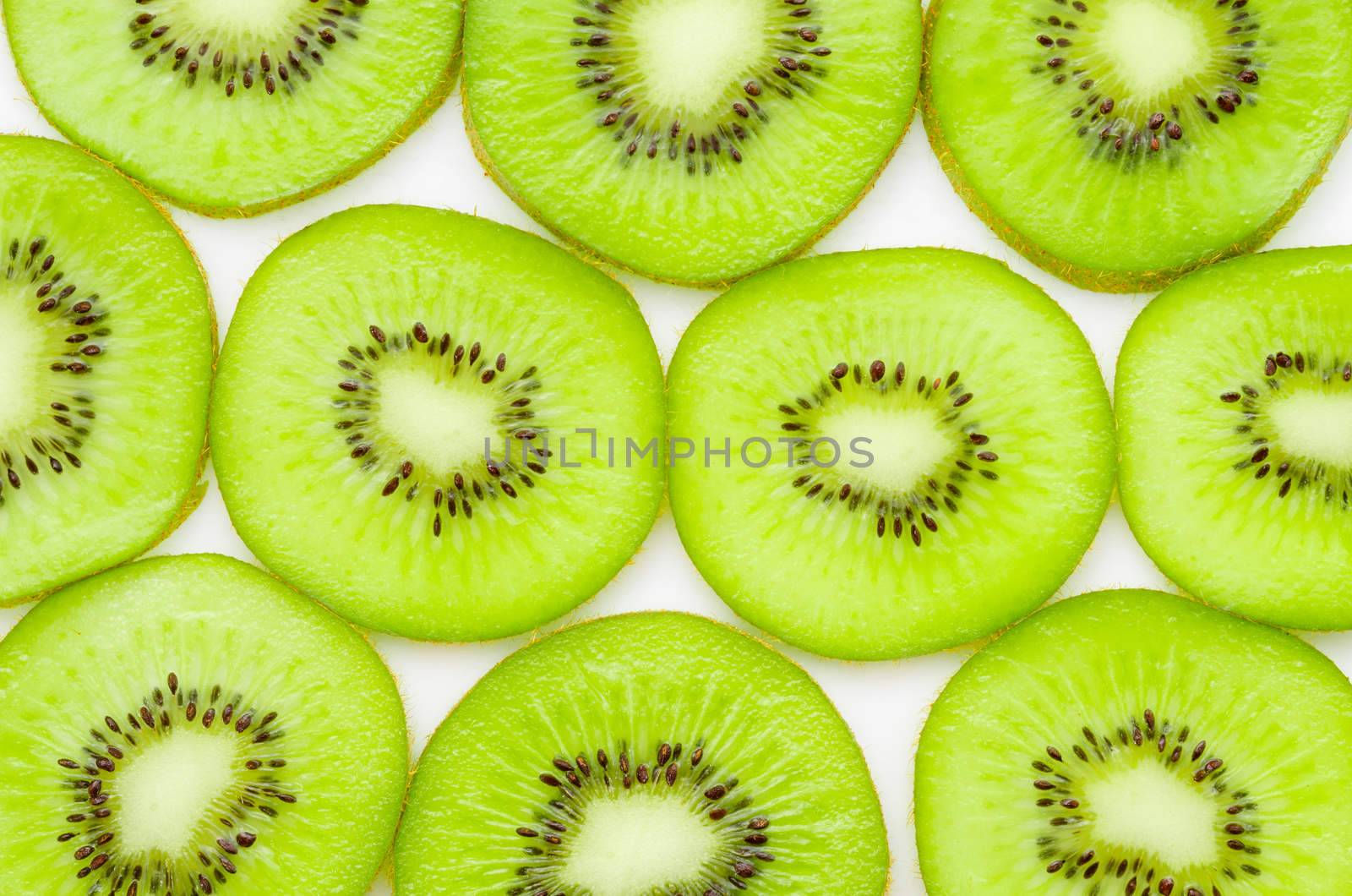 Fresh organic Kiwi fruit slices on white background.