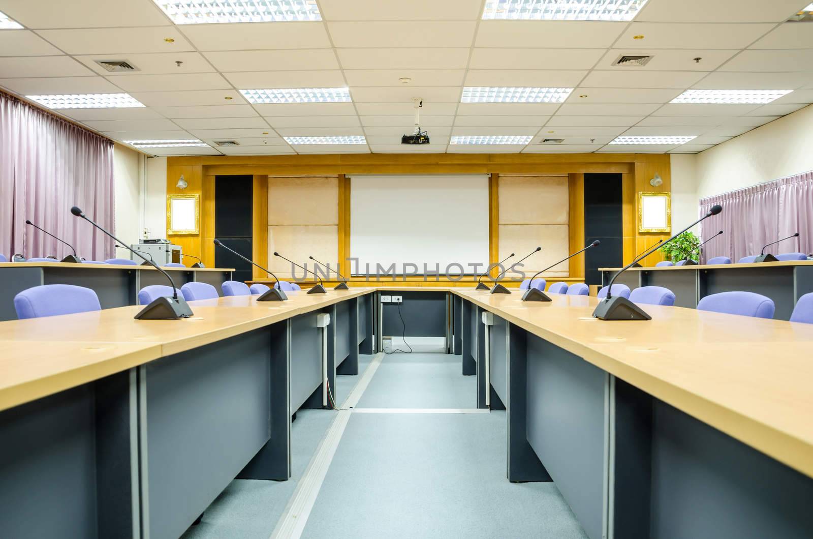 Interior conference room with white projector board. by Gamjai