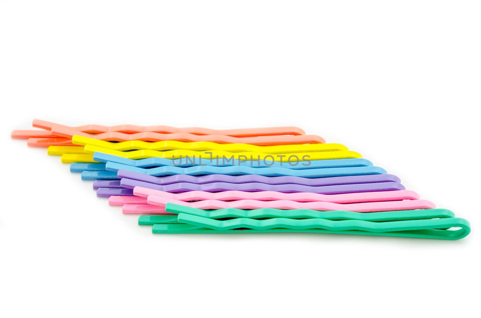 Colorful hair clips in a row isolated on white background.
