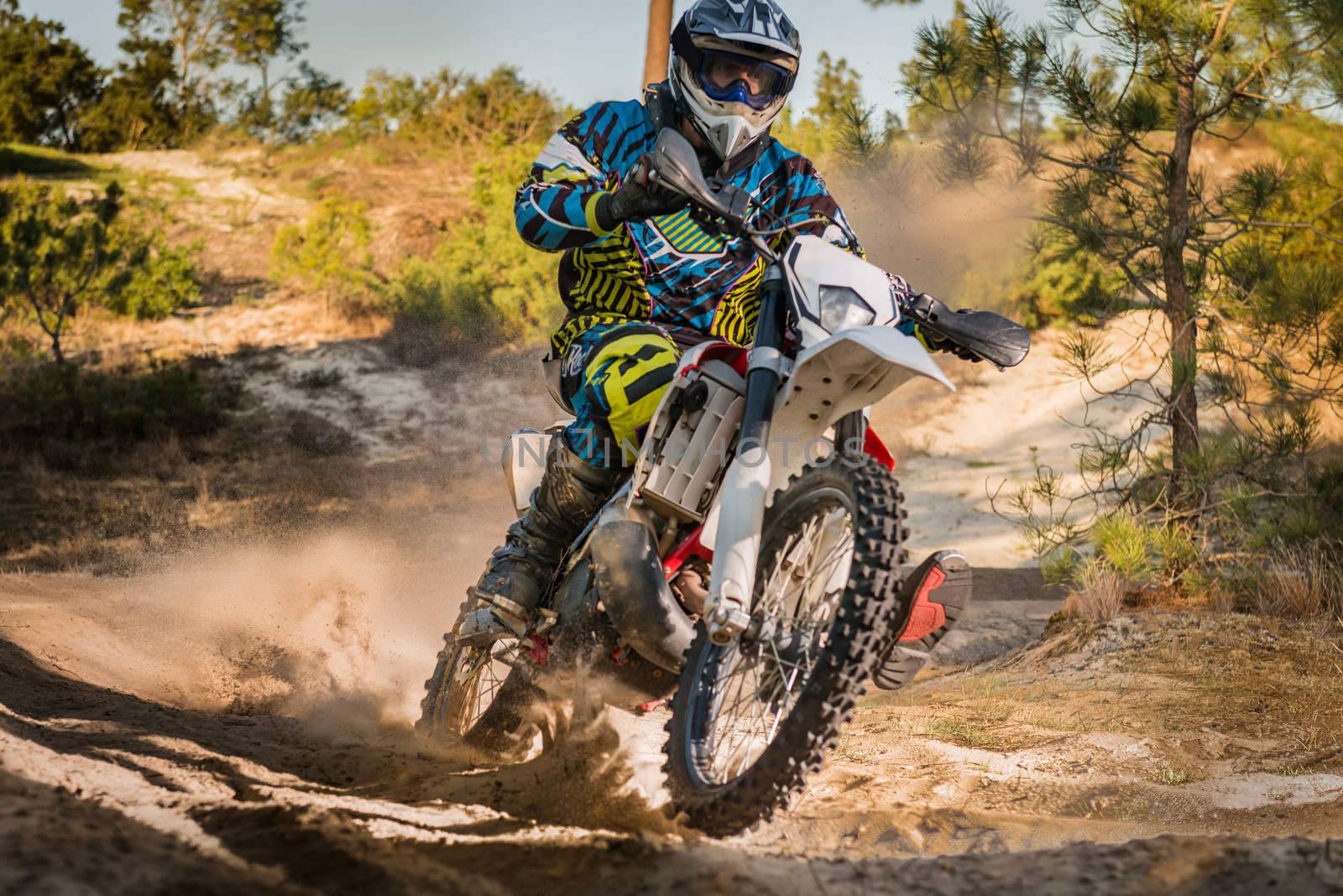 Enduro bike rider on action. Turn on sand terrain.