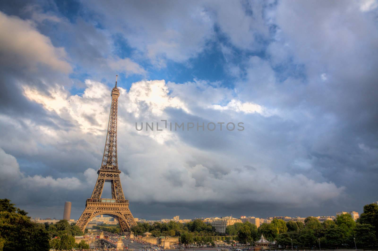 Dramatic stormy clouds forming over Eiffel Tower in Paris on summer evening