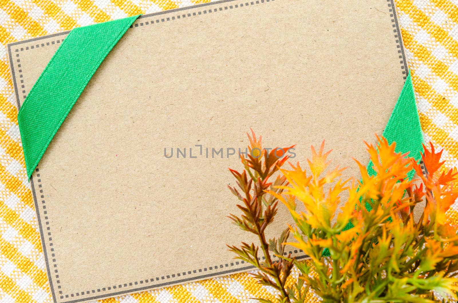 Blank brown paper tag for your text on beautiful fabric. by Gamjai