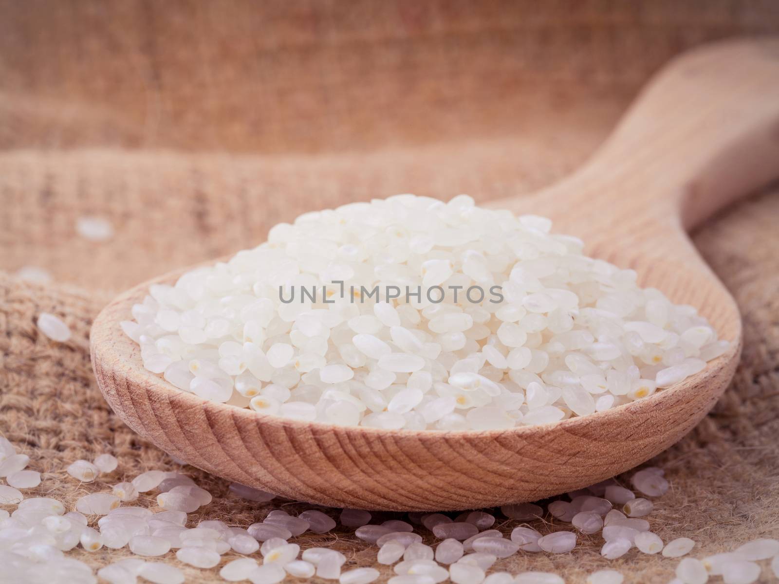 Whole grain traditional japanese rice  in wooden spoon with hemp by kerdkanno