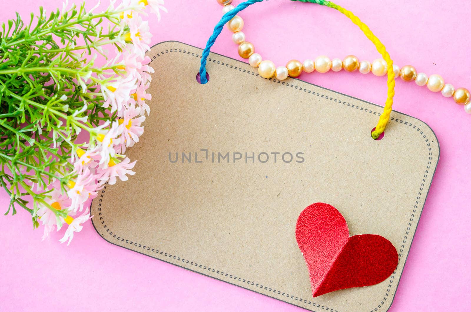Blank brown paper tag and red heart paper with flower. by Gamjai