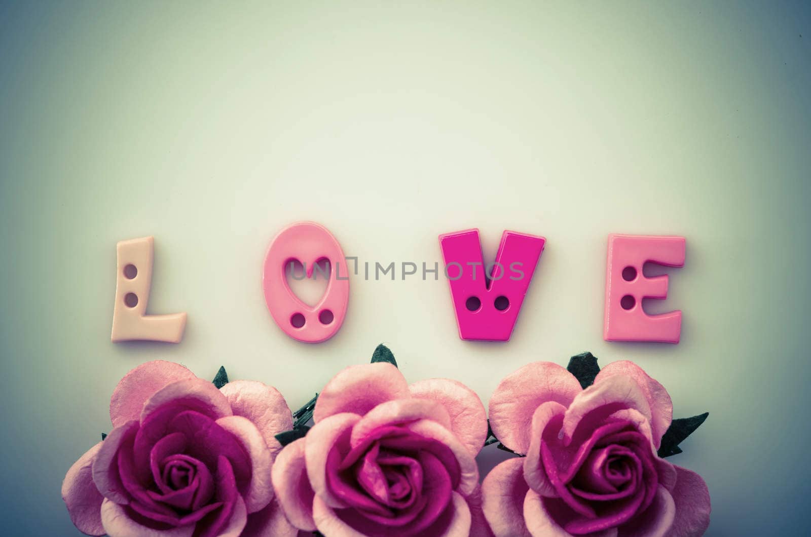 Vintage pink roses flower and love text. by Gamjai