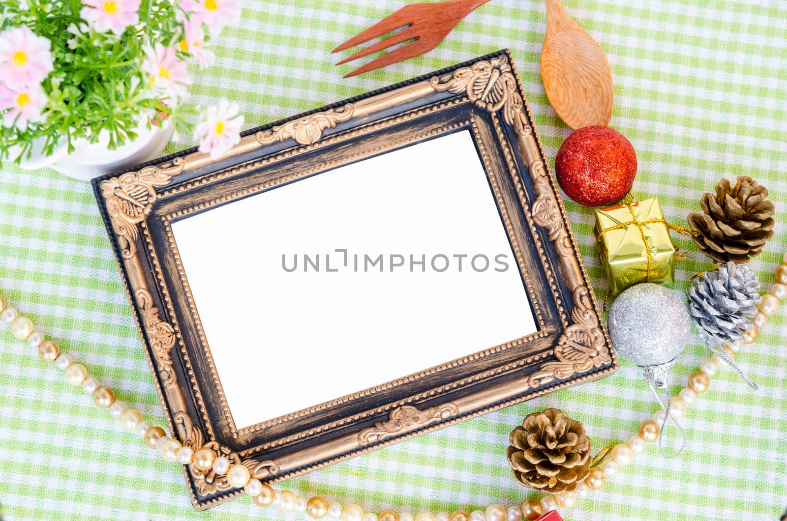 Old vintage photo frame with christmas decoration on tablecloth save clipping path.