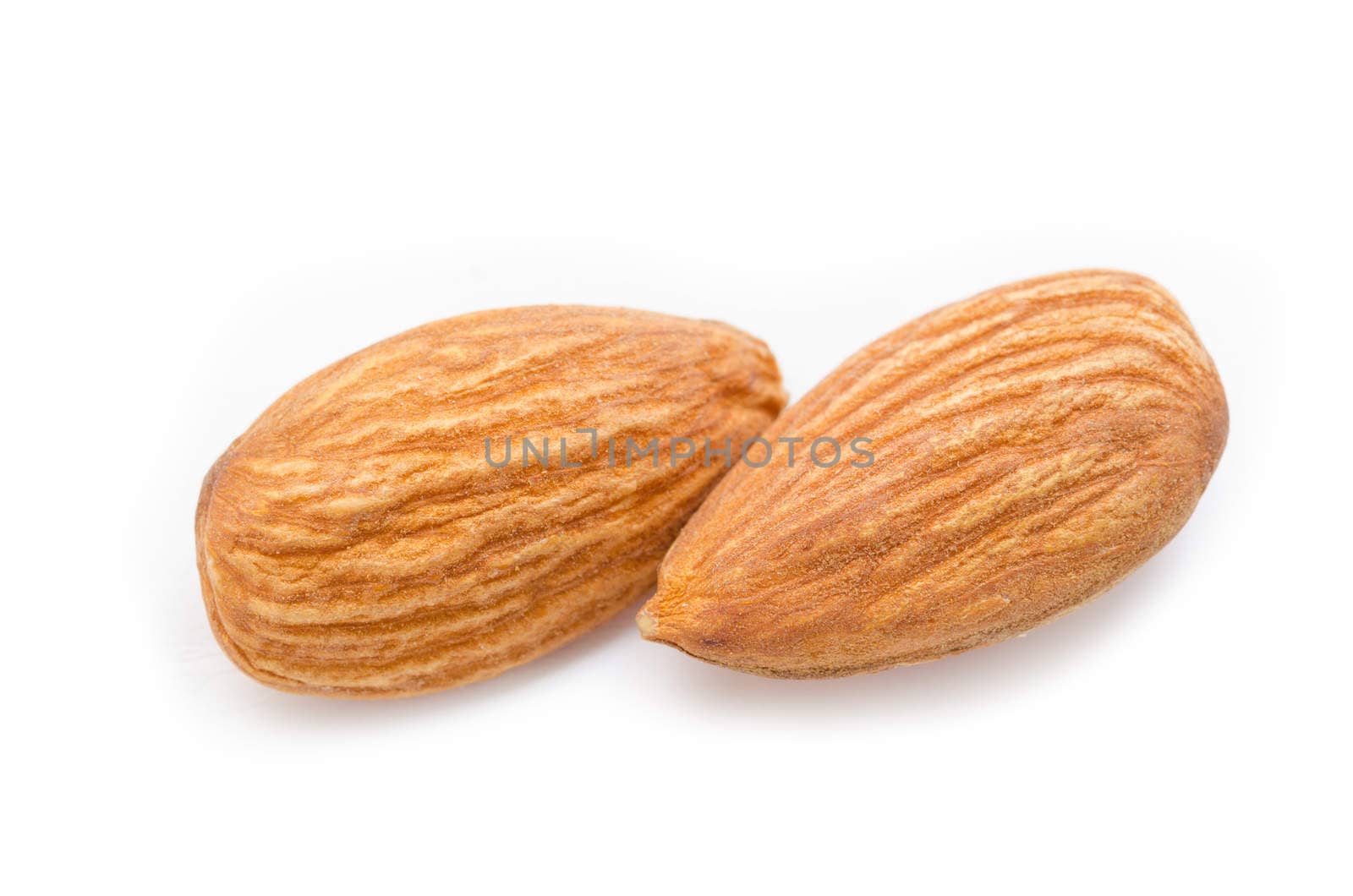 Close up almonds isolated on the white by Gamjai