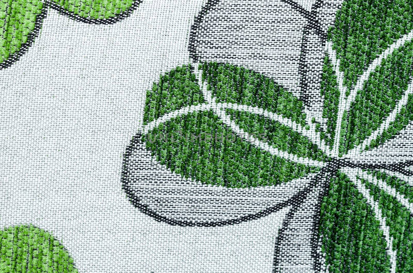 Embroidery of green leaf on linen beige fabric can use as background.