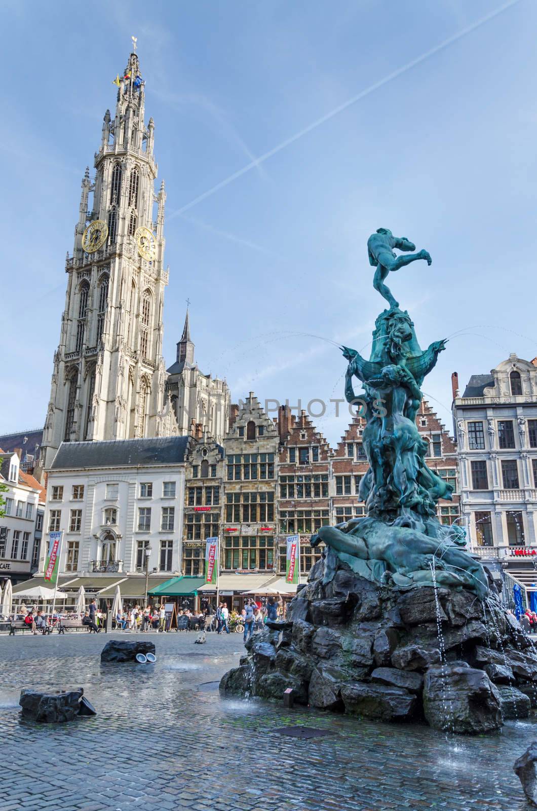 Antwerp, Belgium - May 10, 2015: Tourist visit The Grand Place with the Statue of Brabo, throwing the giant's hand into the Scheldt River and the Cathedral of our Lady. on May 10, 2015 in Antwerp, Belgium.