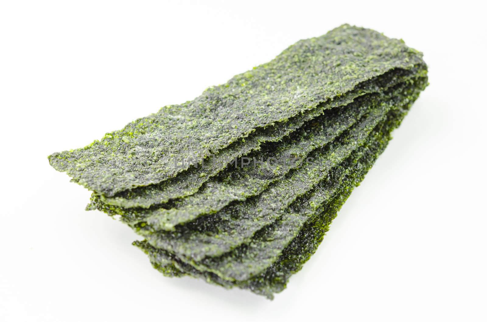 Fried seaweed on white background. by Gamjai