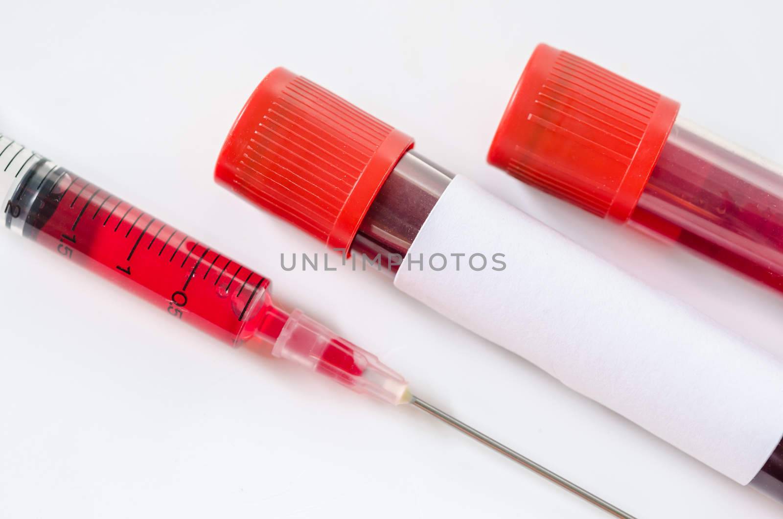 Syringe And Plastic Test Tube. by Gamjai