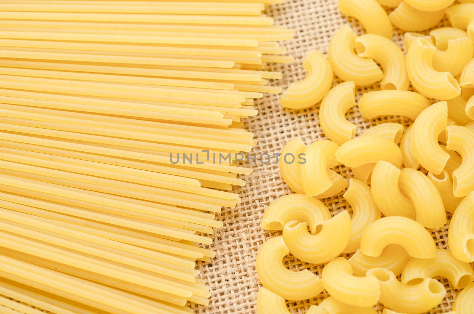 Raw Spaghetti and elbow macaroni. by Gamjai