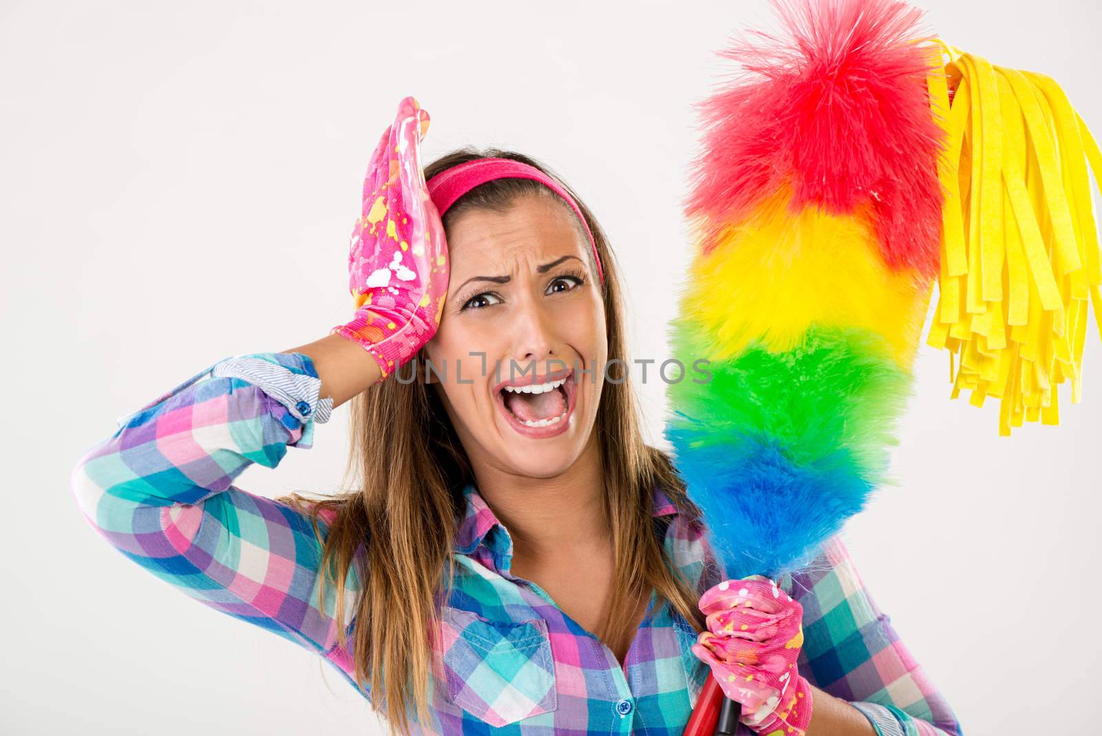 Spring cleaning woman screaming. She is stressed and looking at camera. White background.