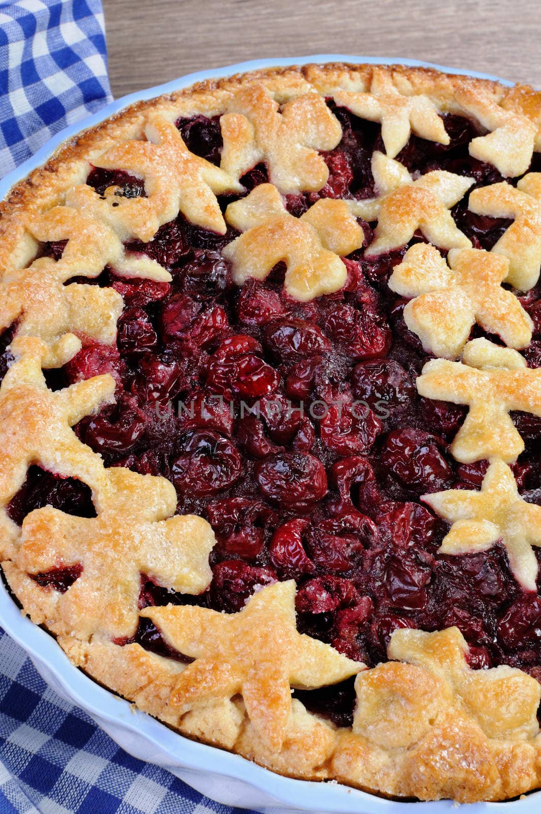 pie with cherry filling decorated flowers and petals  