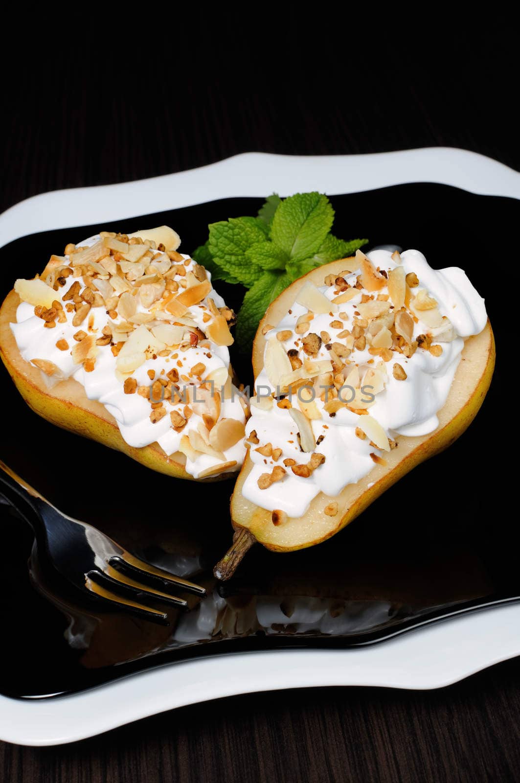 pears with whipped cream sprinkled   nuts and almonds