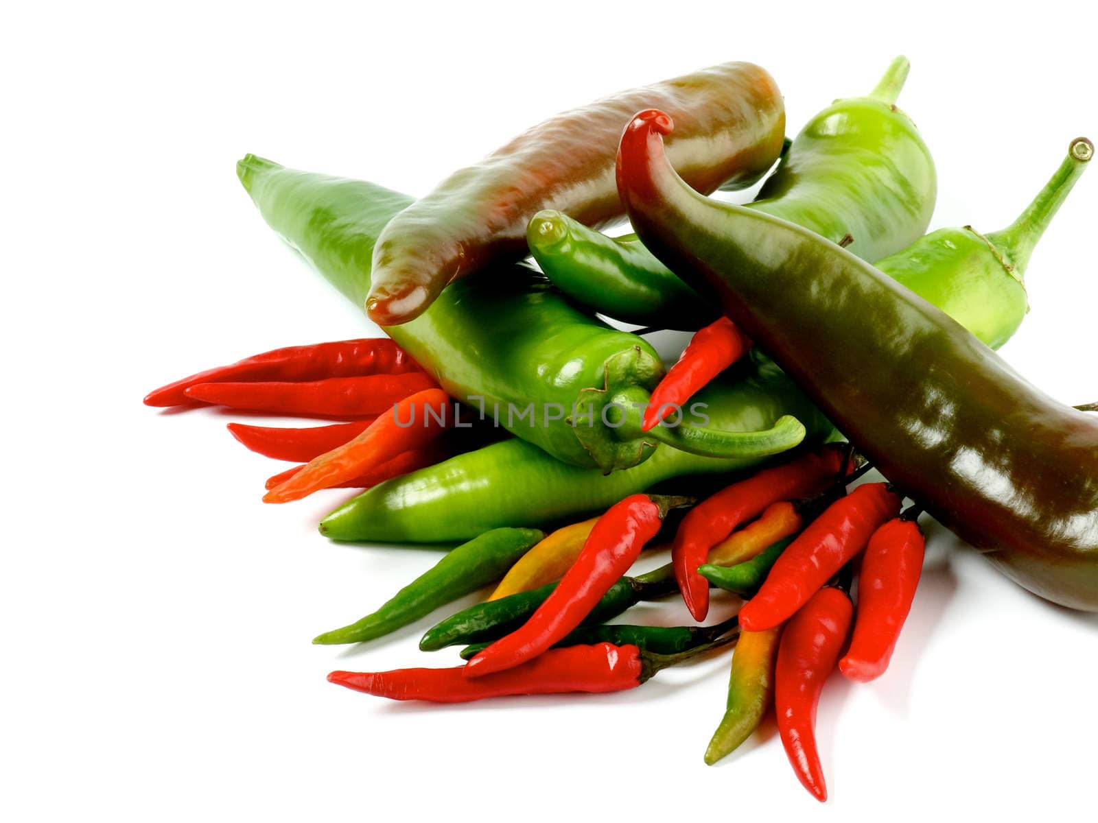 Arrangement of Big and Small Green and Red Chili Peppers closeup on White background